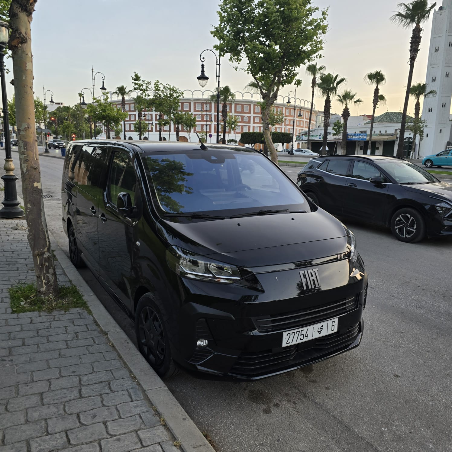 Black Fiat passenger van parked on a street in Tangier