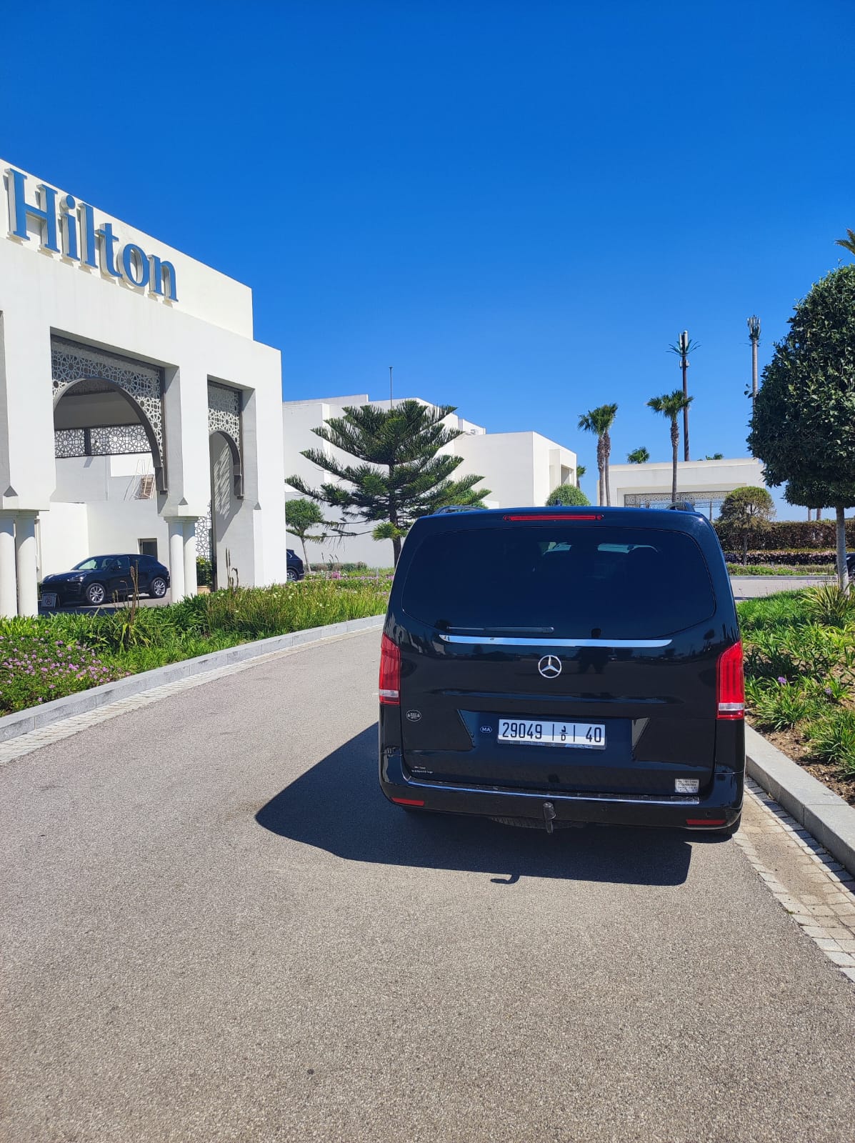 Rear of a black Mercedes-Benz V-Class at a hotel entrance